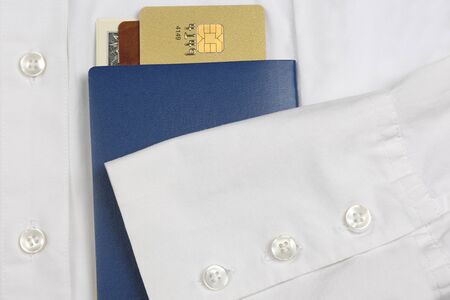 passport, money and Bank cards are on a white shirt with sleeves