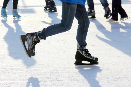 The legs of a man skating on the ice rinkの写真素材