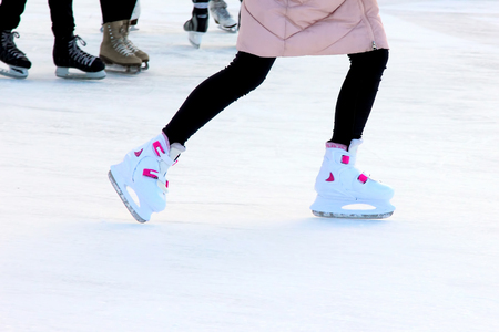 foot ice-skating girls on the ice rinkの写真素材