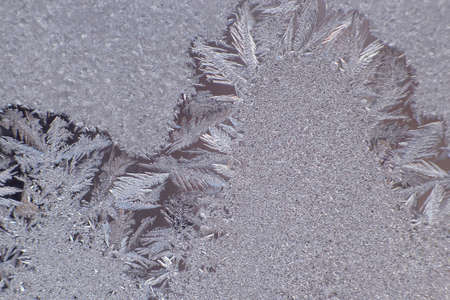 frosty patterns on the window glass closeup