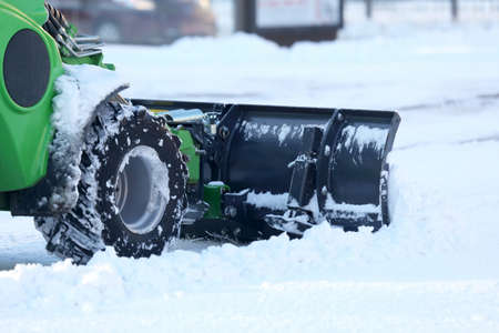 street cleaning the city from snow with the help of special equipment mini