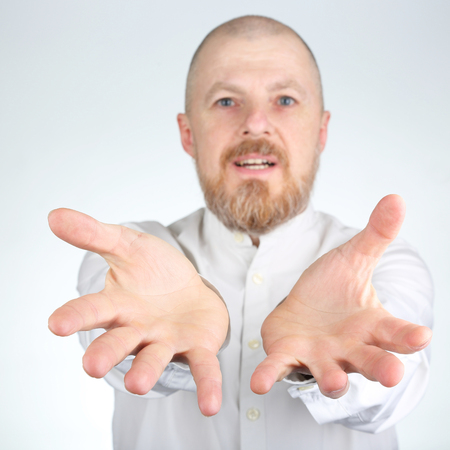 Bearded man stretches his arms forward