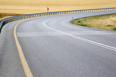 Road in the field with a turn to the right