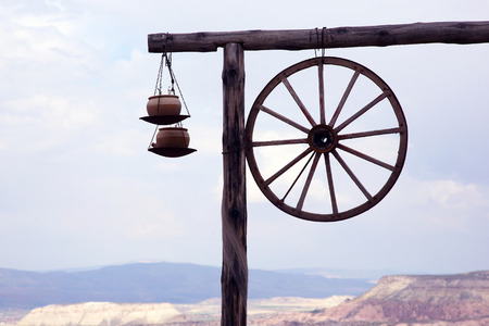 log with clay pots and a cart wheel against a mountain landscape
の写真素材