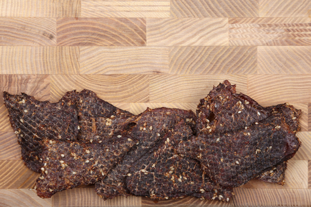 dried beef slices in spices with sesame seedsの写真素材