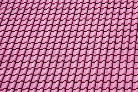 Decorative pink tiles on the roof of the houseの写真素材