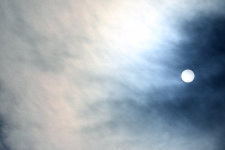 solar disk at noon through the cloudsの写真素材