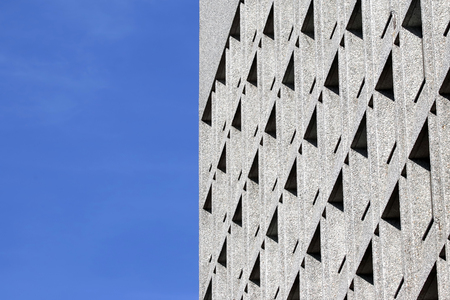 The facade of the building with Windows on the background of blue skyの写真素材