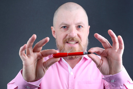 Studio portrait of business men with red pen in handの写真素材