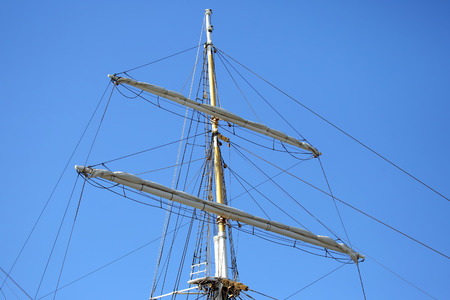 masts of the sailboat on the background of the sky
