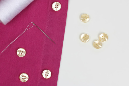 sewn with a needle with white threads pearl buttons on the shirt