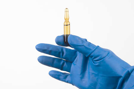 medical injection ampule in blue gloved handの写真素材