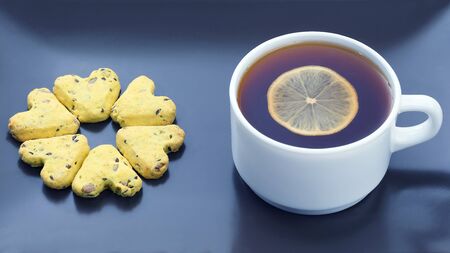 white cup of tea with lemon and biscuits. dessert foodの写真素材