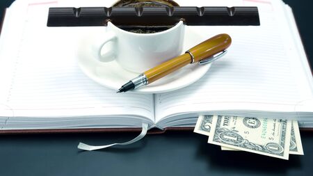 black coffee and chocolate on the table from a business person. hot drink