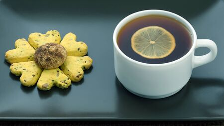white cup of tea with lemon and biscuits. hot drinkの写真素材