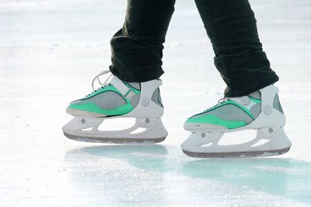 the legs of a man skating on the ice rink. sports, Hobbies and recreation of active people