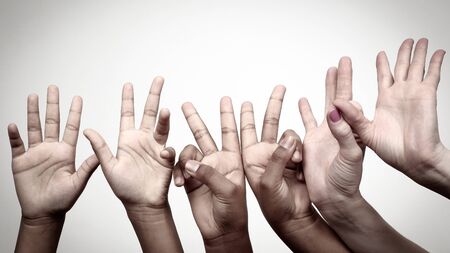 many raised children's expressive hands in a row. gestures emotionsの写真素材