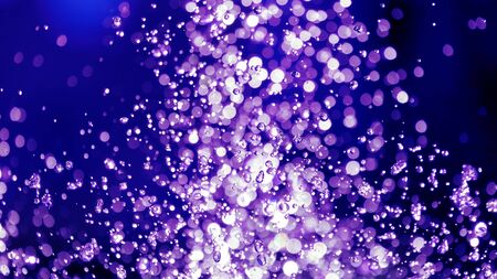 the blurred drops of water spray fountain. Abstraction and blurring in the play of water and light