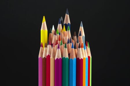 Colored pencils for drawing on a dark background. Education and creativity. Leisure and artの写真素材