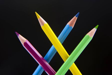 Colored pencils for drawing on a dark background. Education and creativity. Leisure and art