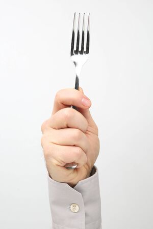 Male hand holds a table fork on a white background
の写真素材