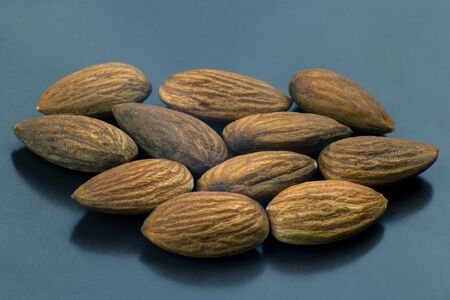walnut almonds handful close-up on a dark plateの写真素材