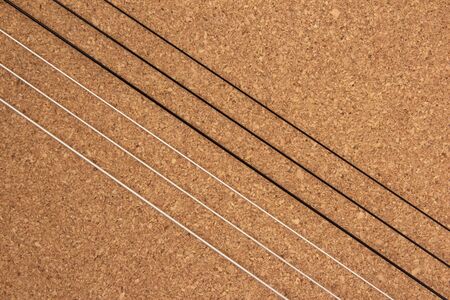 Classical guitar strings on balsa wood texture background
