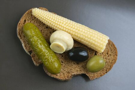 breakfast of canned and pickled olives, cucumber mushrooms with bread.  food and vegetables. diet and weight lossの写真素材