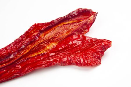 Dried hot red pepper on a white background. Food and spices.