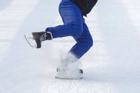 man actively skates on an ice rink. Hobbies and sports. Vacations and winter activities.の写真素材