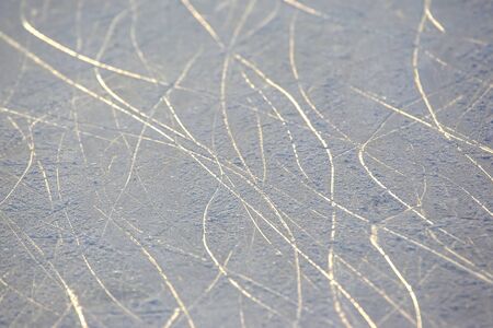 bright traces of ice skating on an ice rink. background and texture