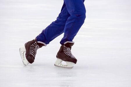Legs of a man skating on an ice rink. Hobbies and sports. Vacations and winter activities.
の写真素材