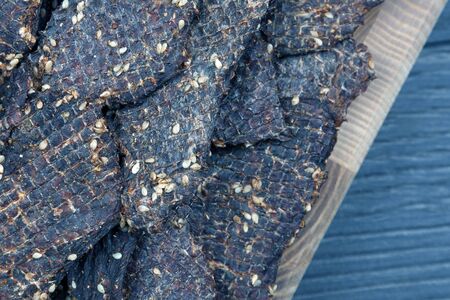 dried beef slices in spices with sesame seedsの写真素材