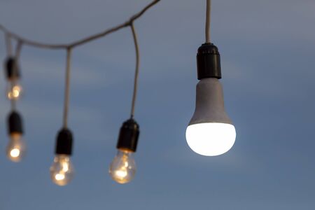 LED lamp shines on the background of electric lamps in the street. electric lighting of streets and...