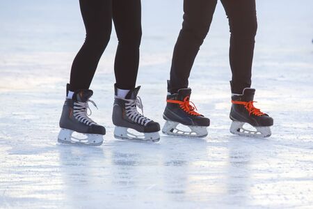 feet on the skates of a person rolling on the ice rink. Hobbies and sports. Vacations and winter activities.の写真素材