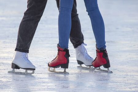 different people are actively skating on an ice rink. hobbies and leisure. winter sports
