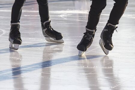different people are actively skating on an ice rink. hobbies and leisure. winter sportsの写真素材