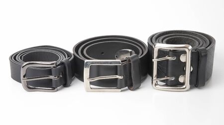three black leather belt on a white background. items and clothing accessories