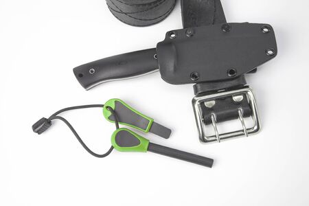 knife for tourism and hunting with a plastic case on a black leather belt on a white background. ignition steel for striking fireの写真素材