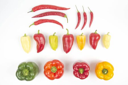 different colored sweet and bitter peppers on a white background. vitamin food