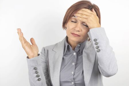 The business woman is tired and worried in emotions. Stress and headache. Working shocks.の写真素材