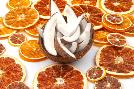 coconut with nut chips on a background of dried citrus fruitsの写真素材