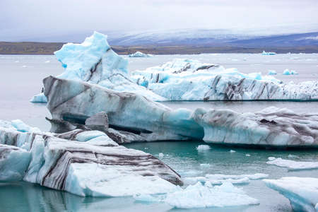 Blue Ice on the shore of the ice lagoon in Icelandの写真素材