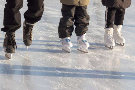 different people are actively skating on an ice rink. hobbies and leisure. winter sportsの写真素材