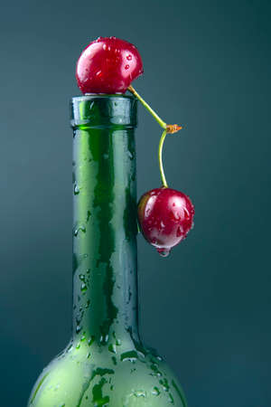 fresh cherry berry with water droplets on a green bottle. healthy food for breakfast. fruits of vegetation. fruit dessertの写真素材