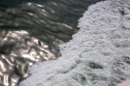 the waves from the ship on the background of the tranquil ocean