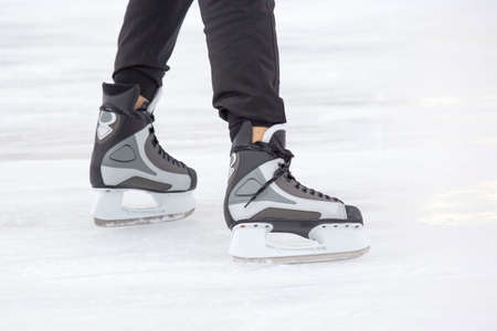 legs of a skating man on an ice rink. hobbies and leisure. winter sportsの写真素材