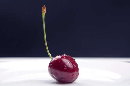 juicy cherry berries lie on a white plate. healthy food for breakfast. fruits of vegetation. fruit dessertの写真素材