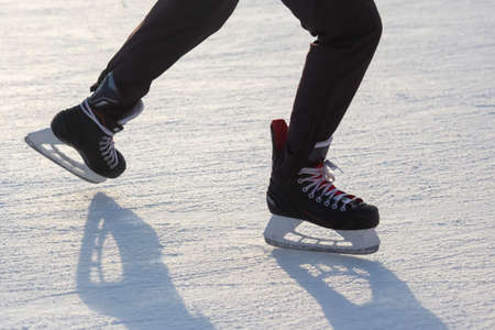 legs of a skating man on an ice rink. hobbies and leisure. winter sportsの写真素材