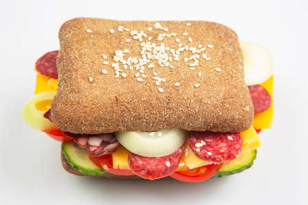 Hamburger with vegetables and sausage on a white background. Fast food and breakfast. Calories and diet.の写真素材